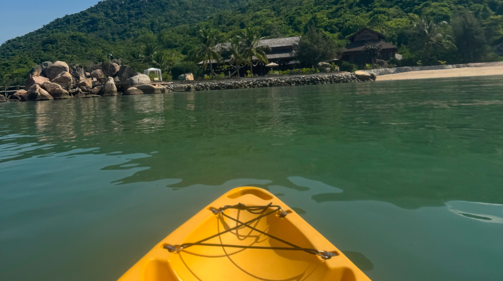 Kayaking activity on calm bay at L'Alya Ninh Van Bay resort couple travel Vietnam